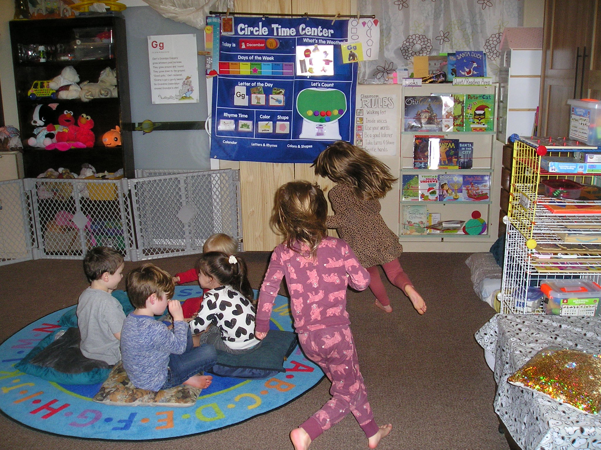 Photo. A group of six children playing duck-duck goose.